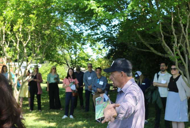 Ezequiel "Zeke" Guzman speaking to a group of funders in Jardin del Pueblo.